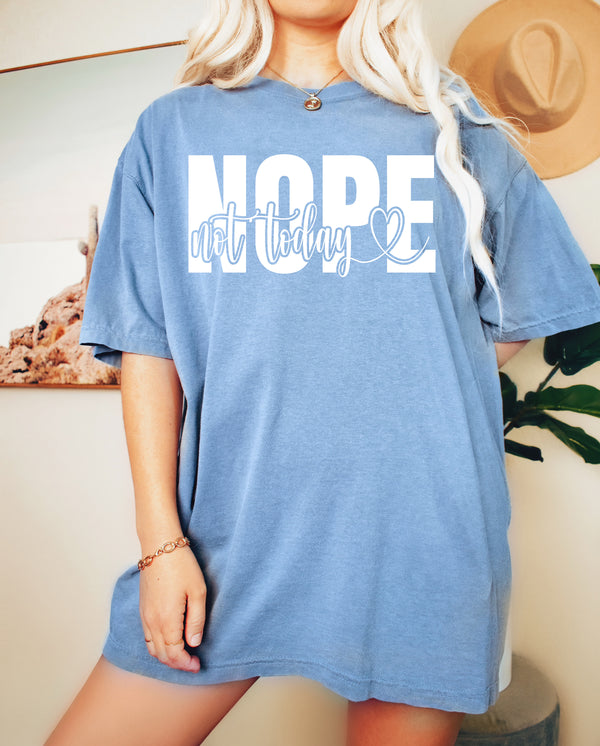 a blonde woman wearing a blue shirt that says nope