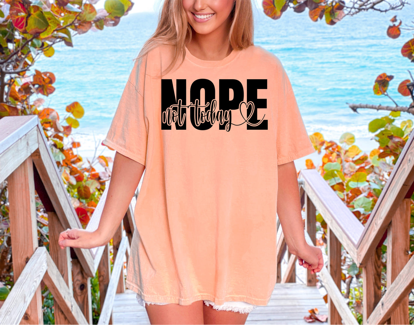 a woman wearing a t - shirt that says nope on it