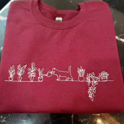 Embroidered Cat Watering Plants Sweatshirt maroon color