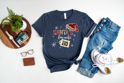 a t - shirt with a santa hat on it next to a pair of jeans