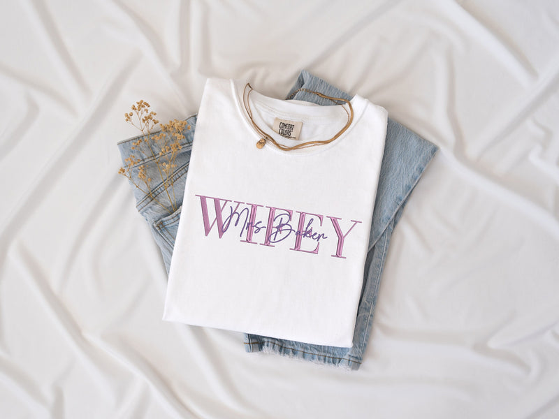 a white t - shirt with the word wheeley printed on it