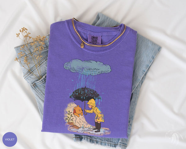 a t - shirt with a picture of a man and a woman under an umbrella