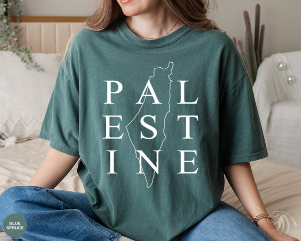 a woman sitting on a bed wearing a t - shirt that says pal est line