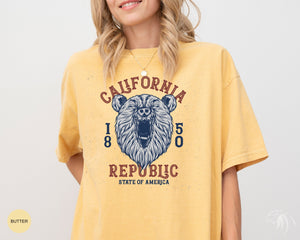 a woman wearing a yellow california bear t - shirt