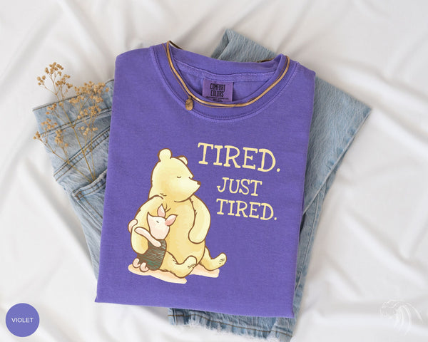 a purple shirt with a winnie the pooh on it